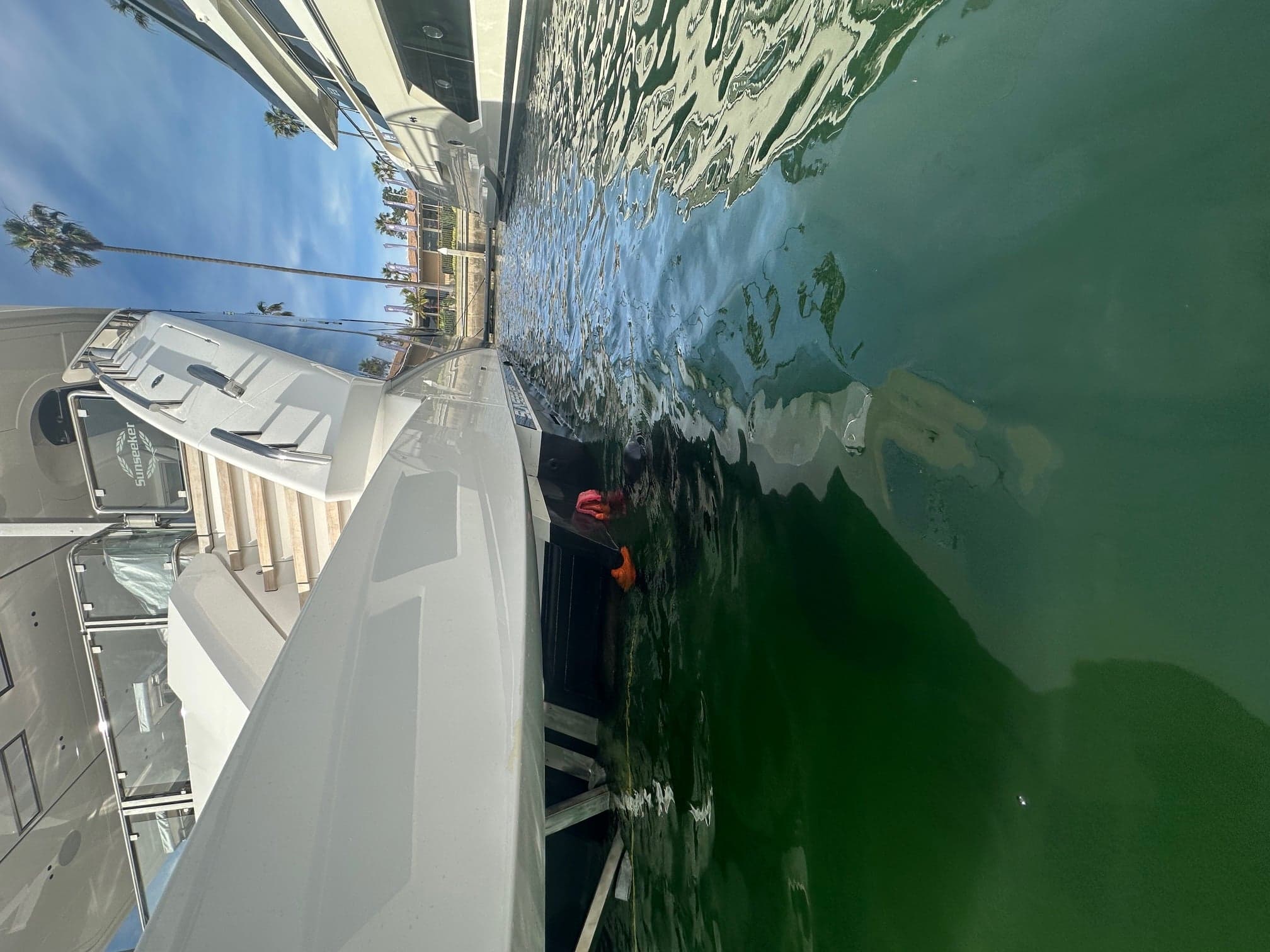 Diver alongside a yacht performing in-water hull service