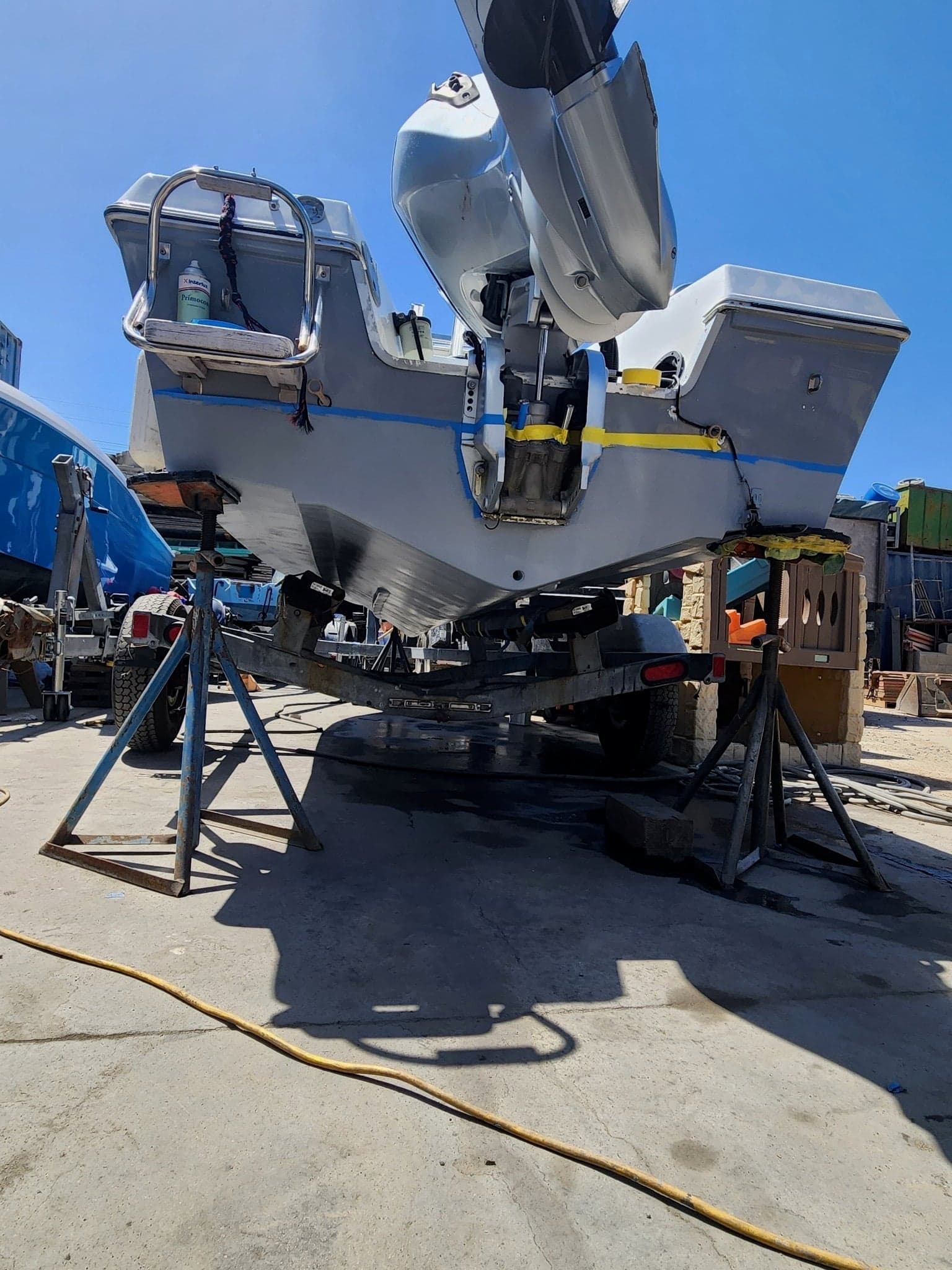 Triple outboard lower units exposed on a center console after pull-out