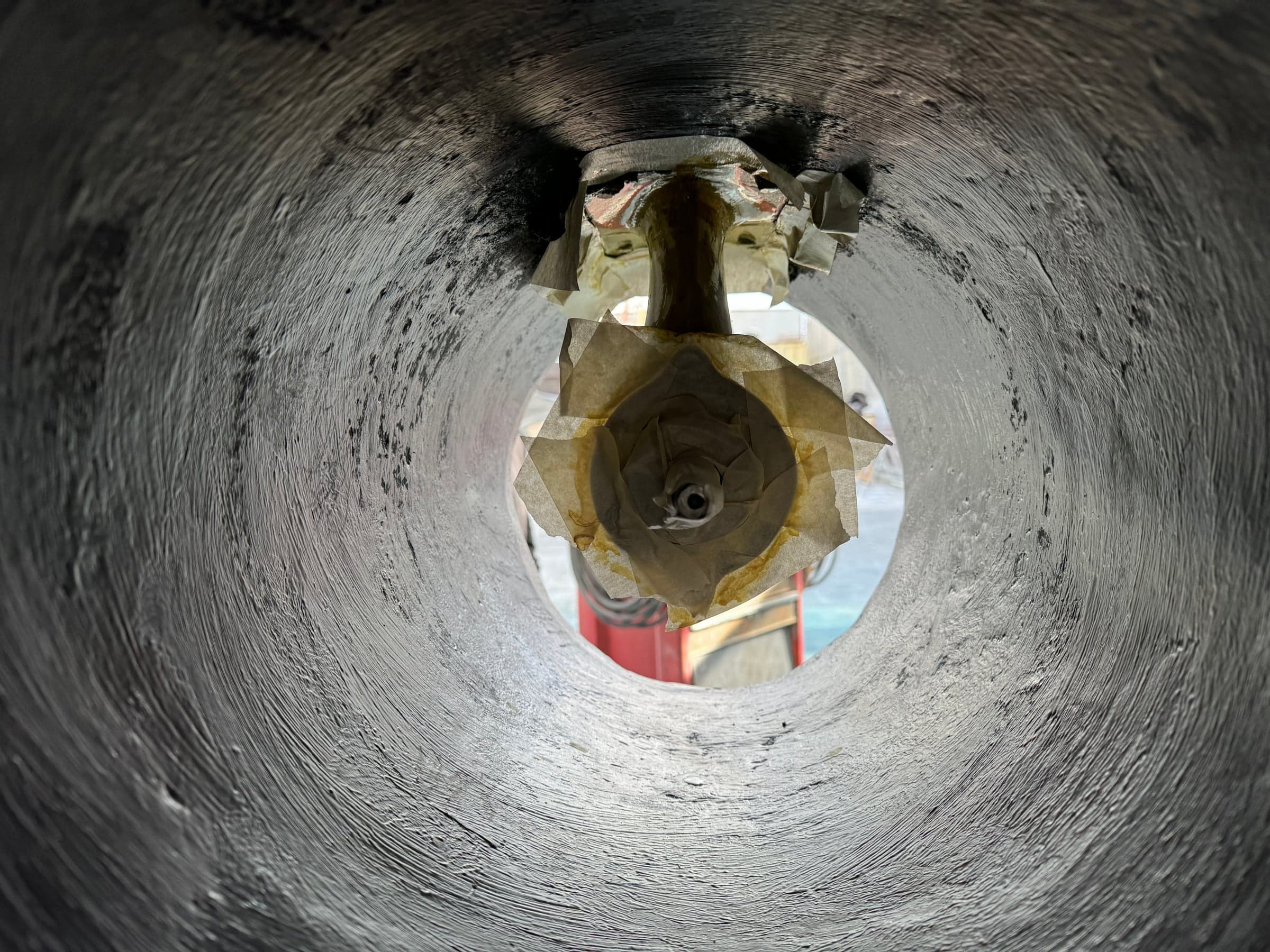 Looking down through a bow thruster tunnel showing prop blades and hub