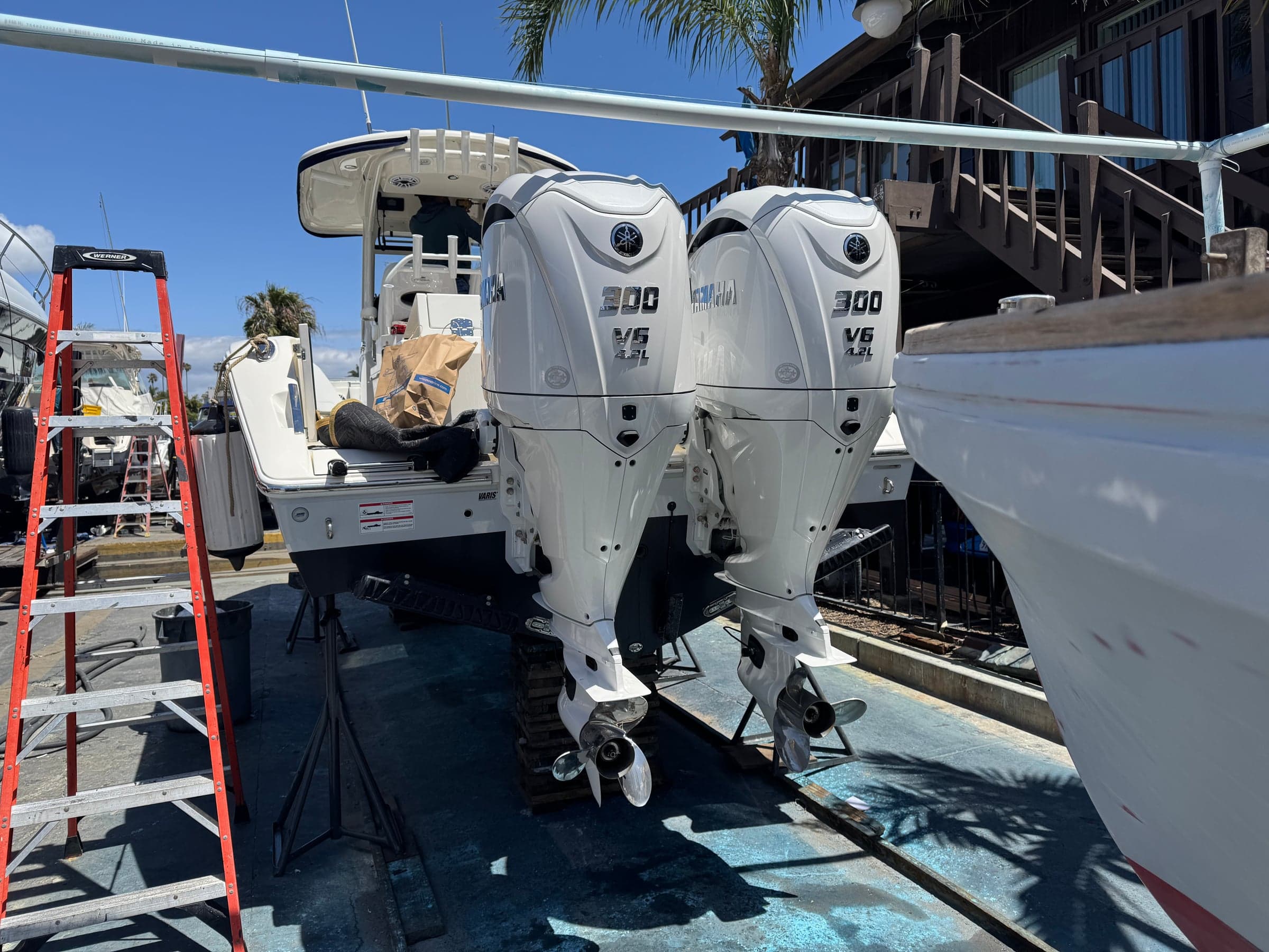 Twin outboard lower units freshly cleaned with stainless props in good condition