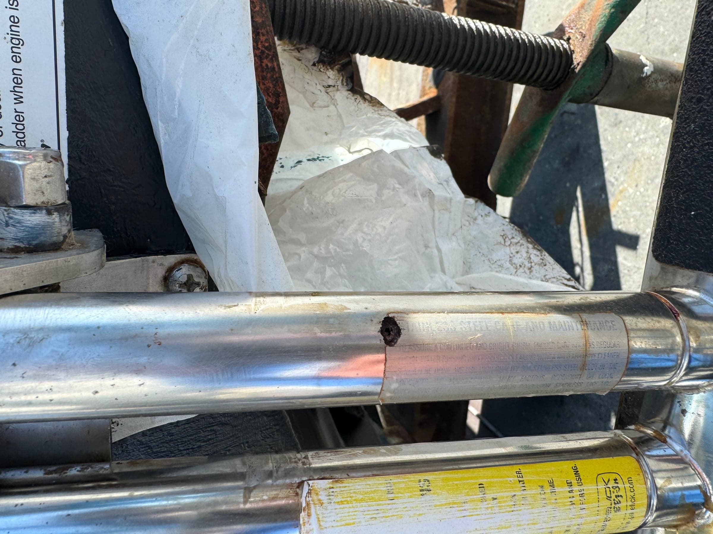 Outboard hydraulic steering ram with through-pitting and a visible hole in the cylinder