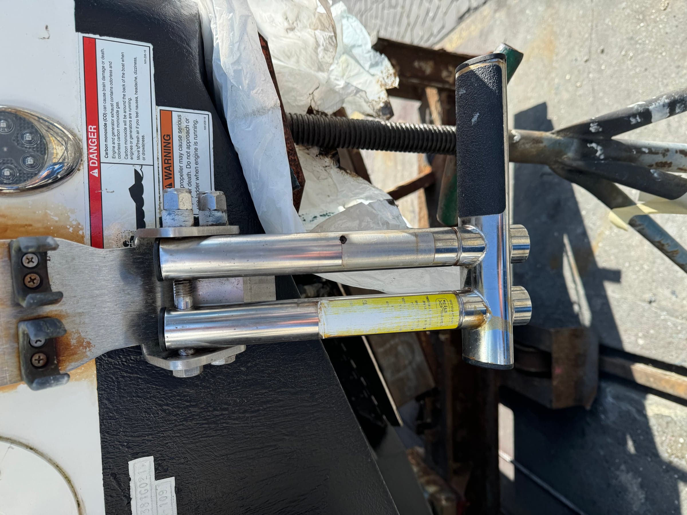 Pair of polished hydraulic steering rams pulled from an outboard for inspection