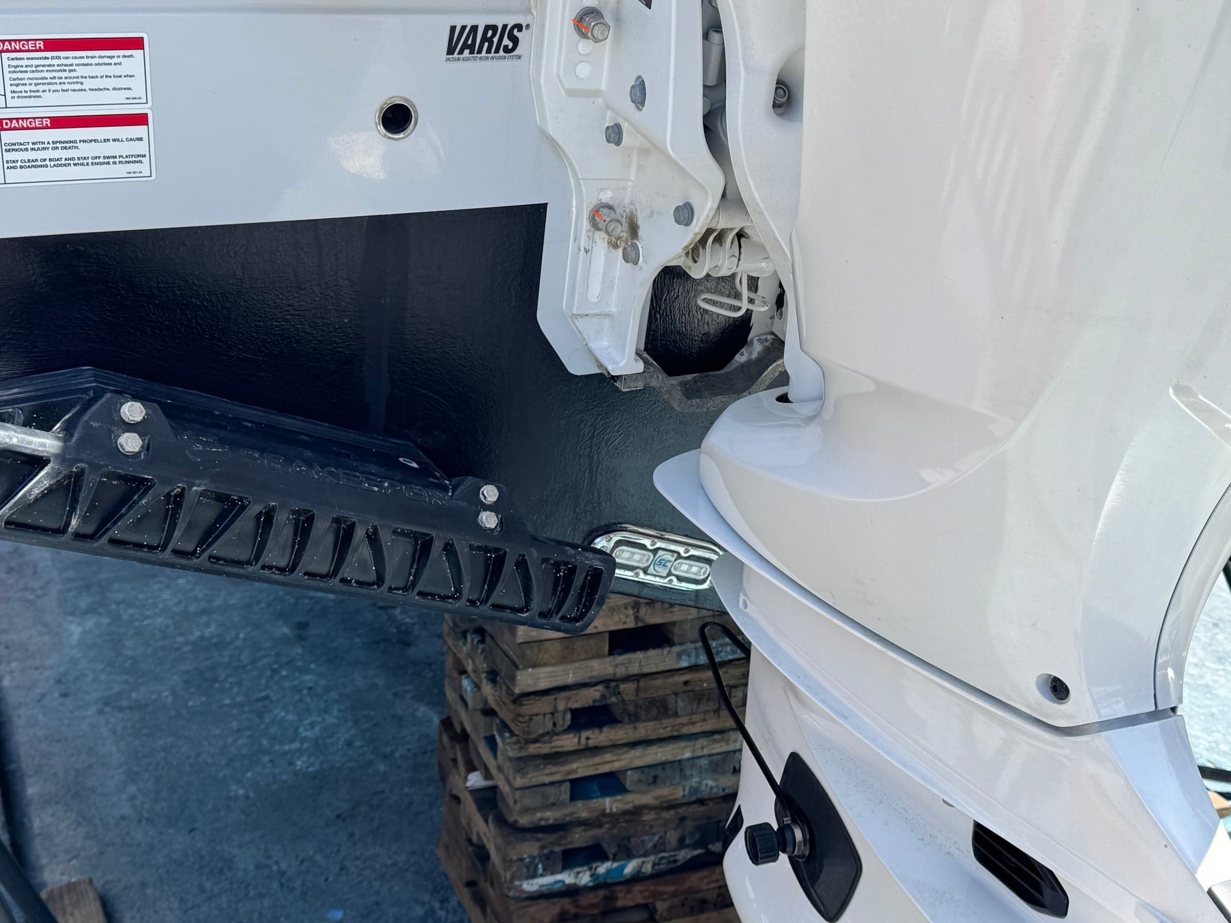 Fresh anode bolted to the anti-cavitation plate of an outboard lower unit