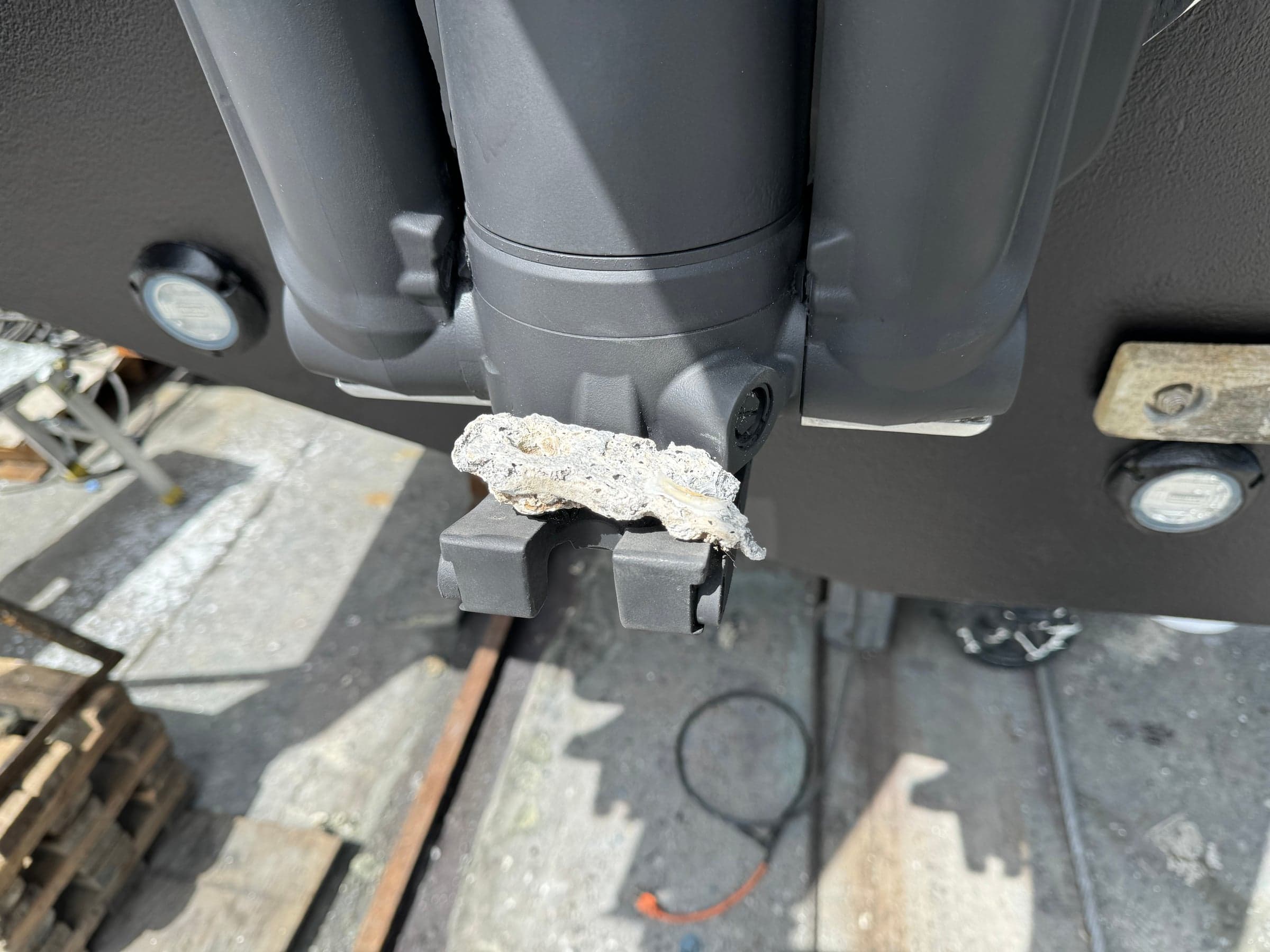 Outboard tilt ram with white epoxy patch over a corrosion pit
